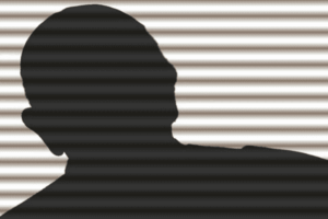 Silhouette of a person against a backdrop of horizontal gray and white stripes. The head is slightly turned to the side, and the shoulders are visible. The image has a shadowy, mysterious look due to the contrast between the dark silhouette and the light background.