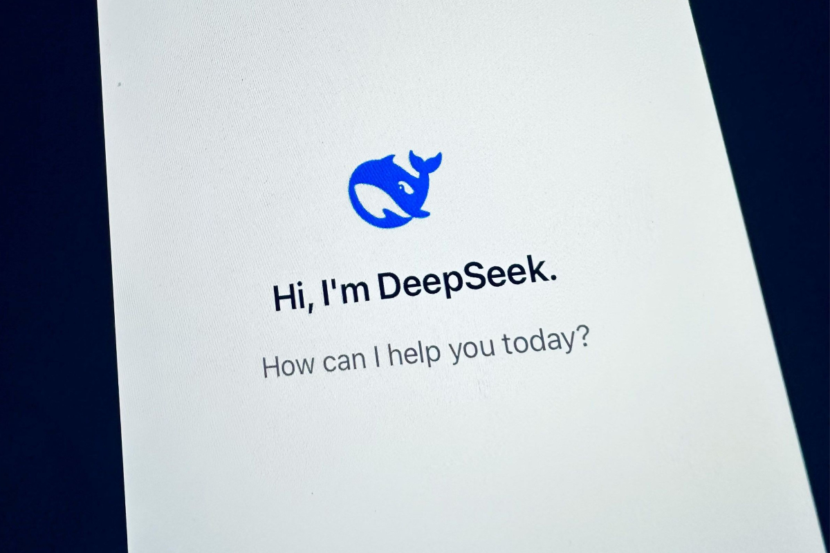 The image displays a smartphone screen with a white background. At the top is a blue logo resembling a whale. Below the logo, the text reads, "Hi, I'm DeepSeek." Further down, a question asks, "How can I help you today?" in gray font.