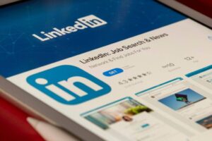 Tablet screen displaying the LinkedIn app page in an app store. Features include the LinkedIn logo, app name "LinkedIn: Job Search & News," a 4.3-star rating, and options to get the app. Screenshot previews of the app interface are visible below the description.